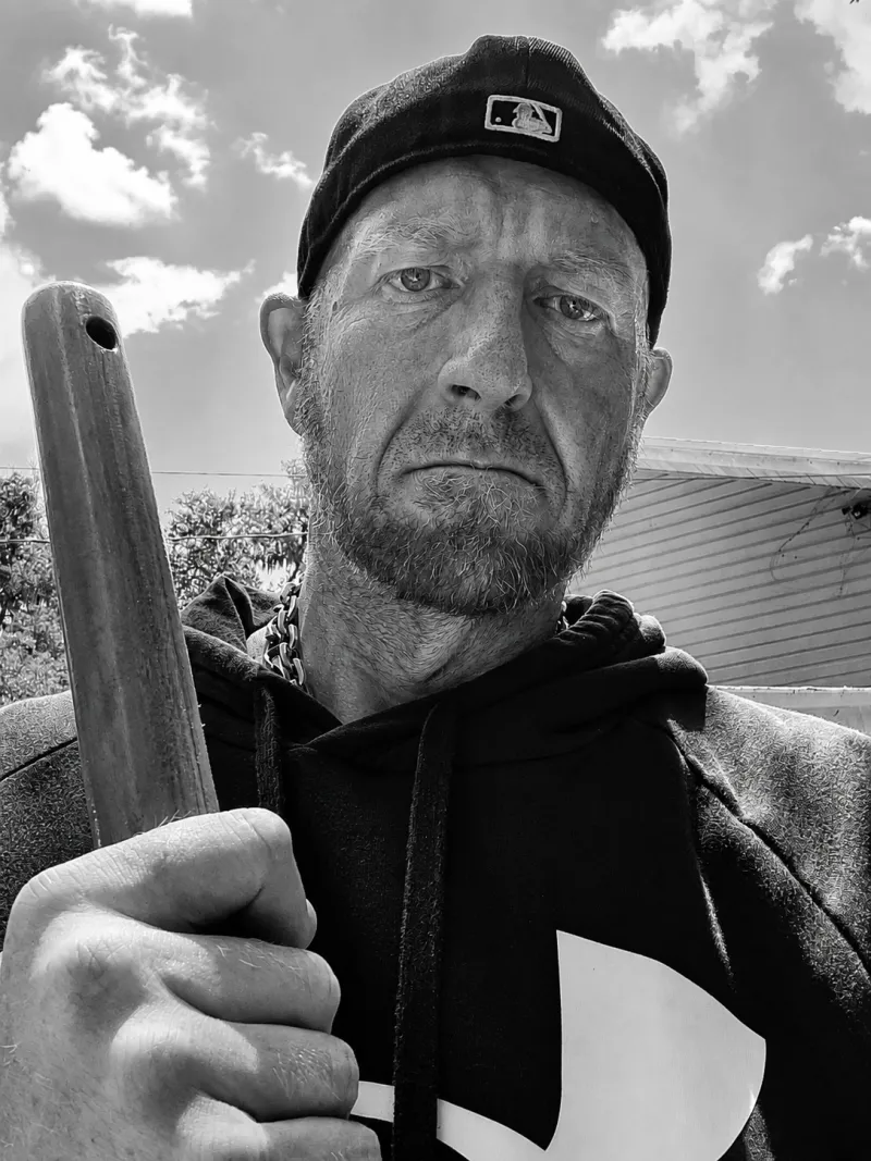Will Schmierer in the field, holding a tool handle